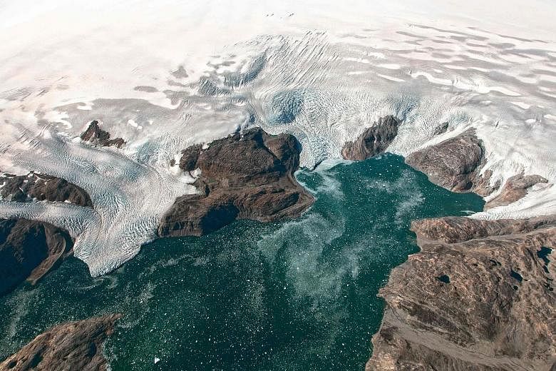 A Nasa Earth Observatory photo taken on Sept 22 last year shows the Bruckner and Heim glaciers where they flow into Johan Petersen Fjord in Greenland. Sea ice in both the Arctic Ocean and around Antarctica is currently at record lows for mid-January,