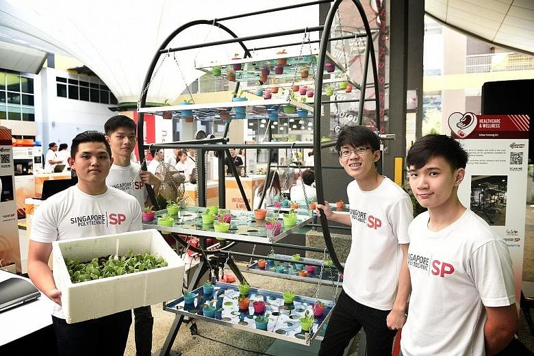 (From far left) Singapore Polytechnic students Tan Gim Yeow, Tan Yi Xuan, Chua Yong Chuan and Louis Szeto Hao Xuan with their urban farming kit, a multi-tiered rotating pot holder that allows more plants to be grown in a given space. WATCH THE VIDEO 