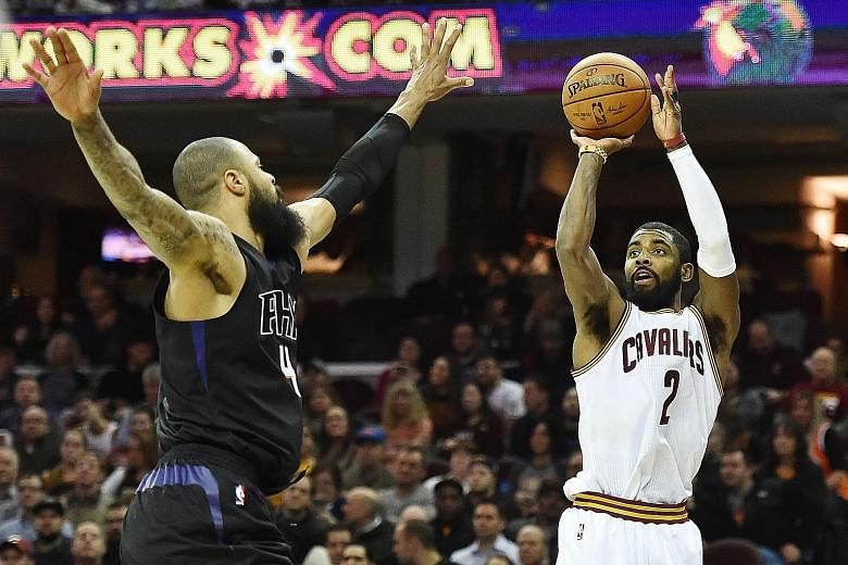 Cleveland Cavaliers point guard Kyrie Irving shooting over Phoenix Suns centre Tyson Chandler in the Cavs' 118-103 win at Quicken Loans Arena in Cleveland on Thursday. Irving (26 points) combined with Cavs superstar LeBron James for 47 points in a co