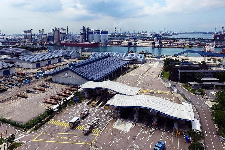 Jurong Port (above) officially opened a new training facility that is expected to benefit about 1,900 workers and help the port reduce its labour dependency by 20 per cent to 30 per cent.