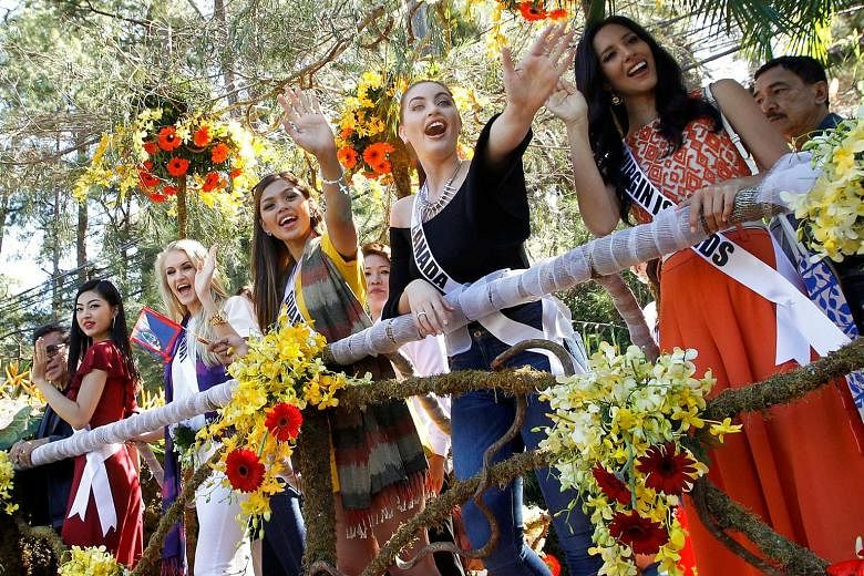 Miss Universe contestants on a float during their arrival and parade in Baguio City in the Philippines on Wednesday. The contestants have been mobbed like rock stars in the Phillipines. Reigning Miss Universe Pia Wurzbach from the Philippines arrivin