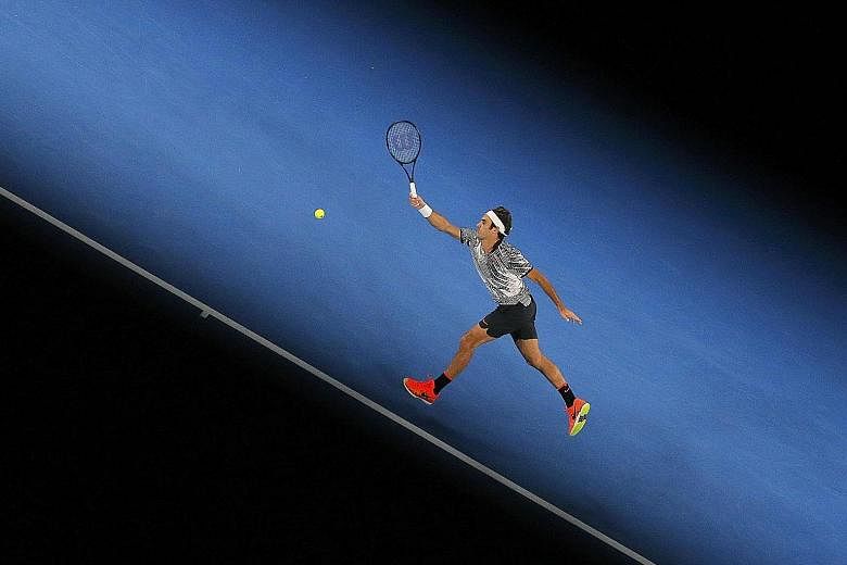Roger Federer hitting a return to Tomas Berdych in his straight-sets vanquishing of the Czech 10th seed. The Swiss made light work of his third- round opponent, taking just 90 minutes to seal his passage into the fourth round where he will face Japan
