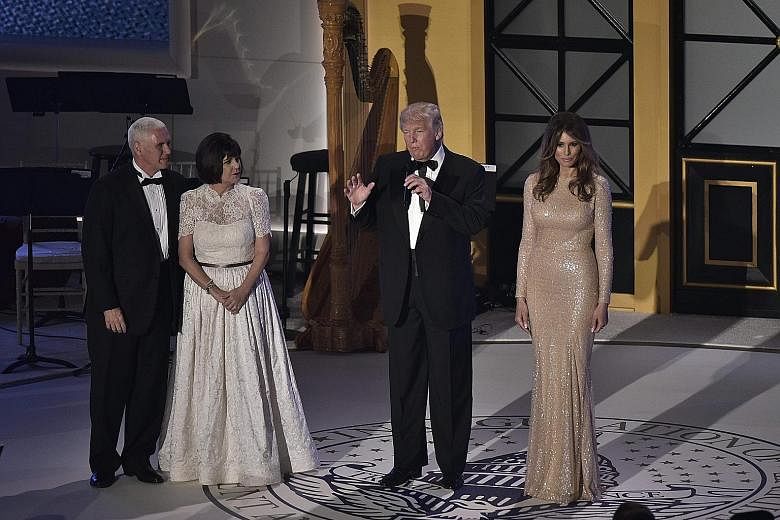 Mr Trump addressing guests during a dinner reception at Union Station on Thursday in Washington, accompanied on stage by (from left) Mr Mike Pence, who was sworn in as Vice-President yesterday, Mrs Karen Pence and Mrs Melania Trump.