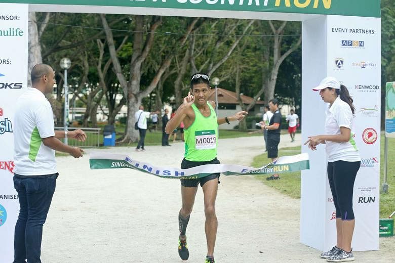 Marcus Ong, 32, celebrates winning the men's open 10km race in the Manulife-Flash X-Country Run event held at Bedok Reservoir yesterday. The races saw over 2,000 runners taking part, with Minister for the Environment and Water Resources Masagos Zulki