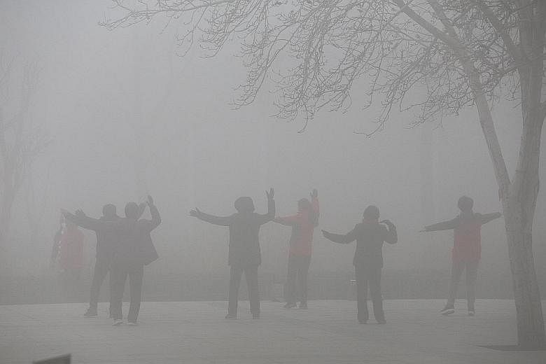 People exercising in the smog on a polluted day in Zhengzhou, Henan province, earlier this month. Lawyer Yu Wensheng hopes that filing lawsuits against the authorities over China's bad air will keep the issue in the public eye.