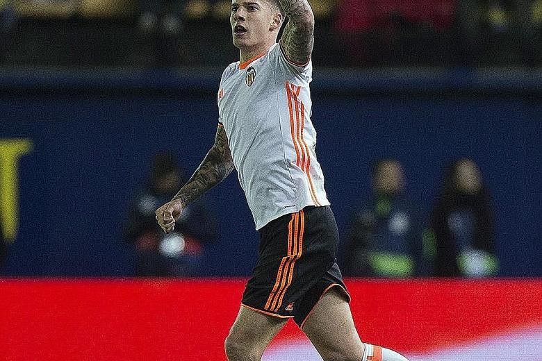 Valencia forward Santi Mina celebrates after scoring in the 42nd minute against Villarreal. The win was also Valencia's first clean sheet of the season.