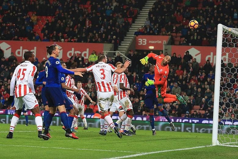 Stoke goalkeeper Lee Grant can only look on helplessly as Wayne Rooney's free kick sails past him into the top corner. The Manchester United forward's goal was his 250th for the club, taking him past the legendary Bobby Charlton as the club's record 