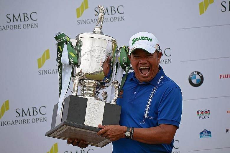 Prayad Marksaeng showing off his trophy after winning the SMBC Singapore Open yesterday. At 50, the Thai golfer is the oldest winner of the US$1 million (S$1.43 million) tournament. SEE SPORT C11