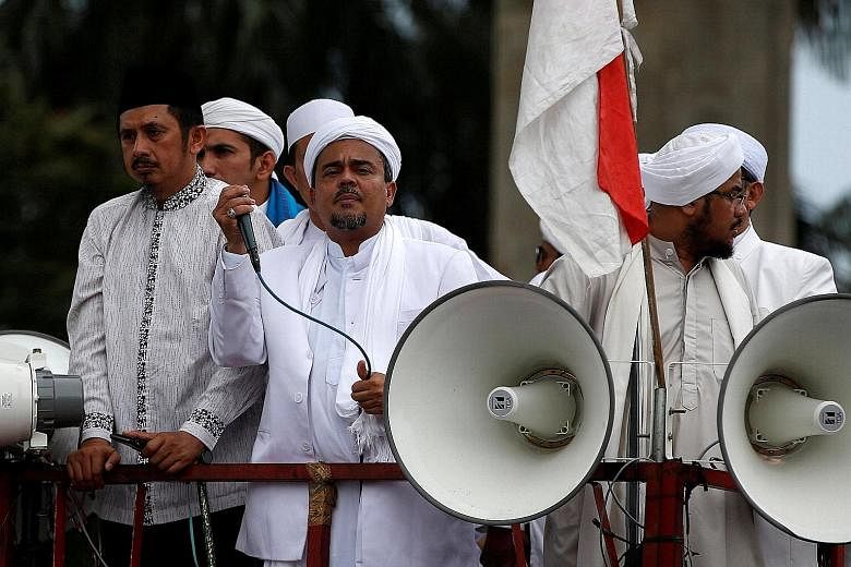 Mr Rizieq (with microphone) leading a protest outside the National Police headquarters in Jakarta last week, in which he called for a provincial police chief to step down over what the FPI says was police violence against its members.