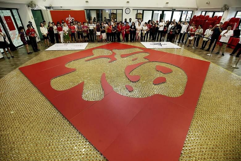More than 1,500 participants baked and toiled over two weekends to make their mark in the Singapore Book Of Records with "The Largest Chinese Character Made With Pineapple Tarts". The tarts - numbering more than 25,000 - were assembled in an 88 sq m 