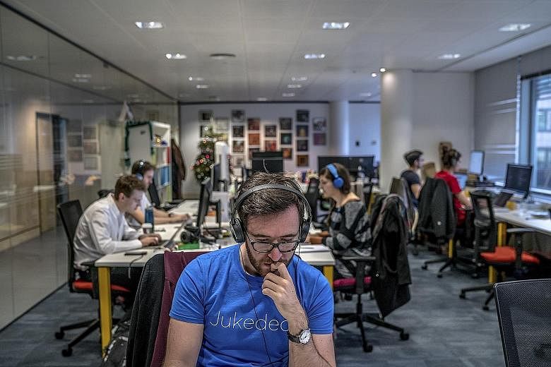 Employees in the London office of Jukedeck (above), which is founded by composer Ed Newton-Rex and Mr Patrick Stobbs.
