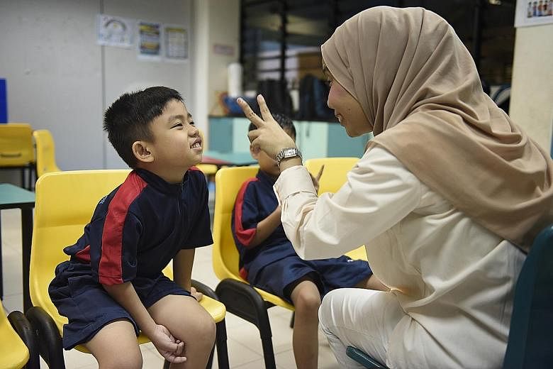 Eight-year-old Aqil Nabil Maulid gave his teacher Hanysah Ismail, 45, a big smile yesterday on his sixth day of school. The boy, who has autism, was homeschooled last year while waiting for a place in Eden School, which caters specifically to childre