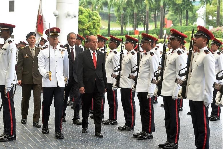 Mr Lorenzana inspecting a guard of honour at Mindef yesterday, accompanied by Dr Ng. The Philippine Secretary of National Defence, who is on a three-day visit here, will visit the Changi Command and Control Centre today for a tour of the Information 