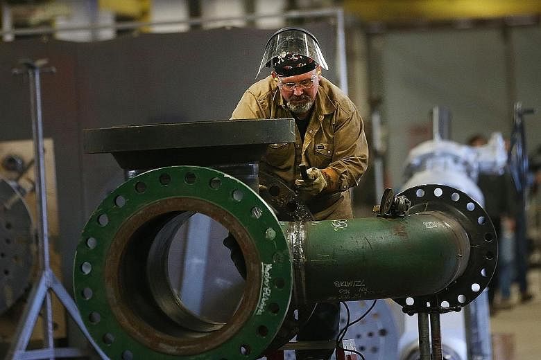 A worker building a pipe in Ohio in the United States. The outlook for the country's economy has brightened. Also, President Donald Trump has put expansionary fiscal policy on the horizon. If fiscal stimulus begins to overheat the economy, the US Fed