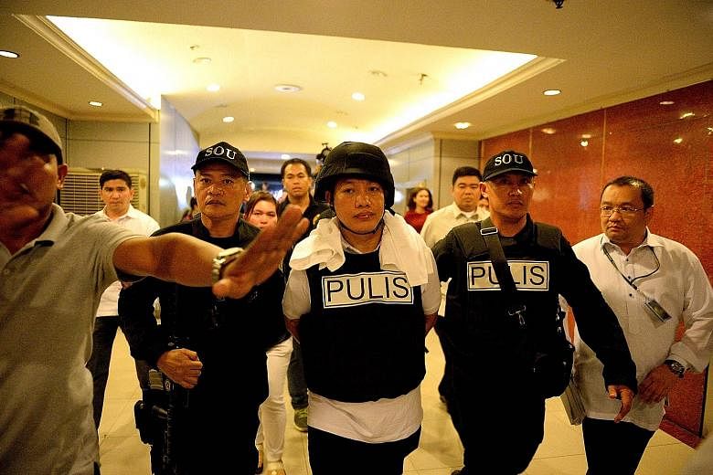 Ricky Sta. Isabel (centre), one of the suspects in the murder of businessman Jee Ick Joo, at the National Bureau of Investigation in Manila last Friday.