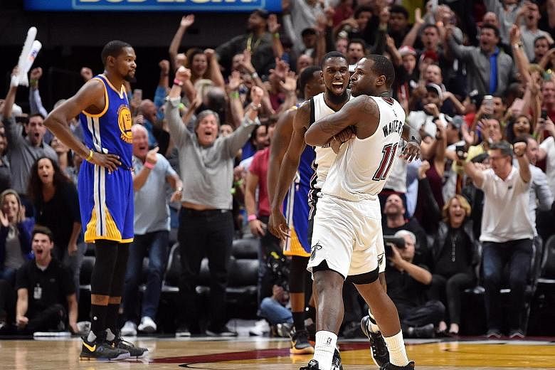 Miami Heat guard Dion Waiters (No. 11) celebrating hitting the game-winning basket against the Golden State Warriors. The Heat upset the league-leading Warriors 105-102.