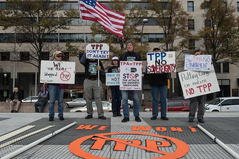 Protesters in the US calling for the rejection of the Trans-Pacific Partnership last year. While President Donald Trump wasted no time in ripping up the trade deal, a new study has found estimates of the impact of trade agreements on the US trade bal