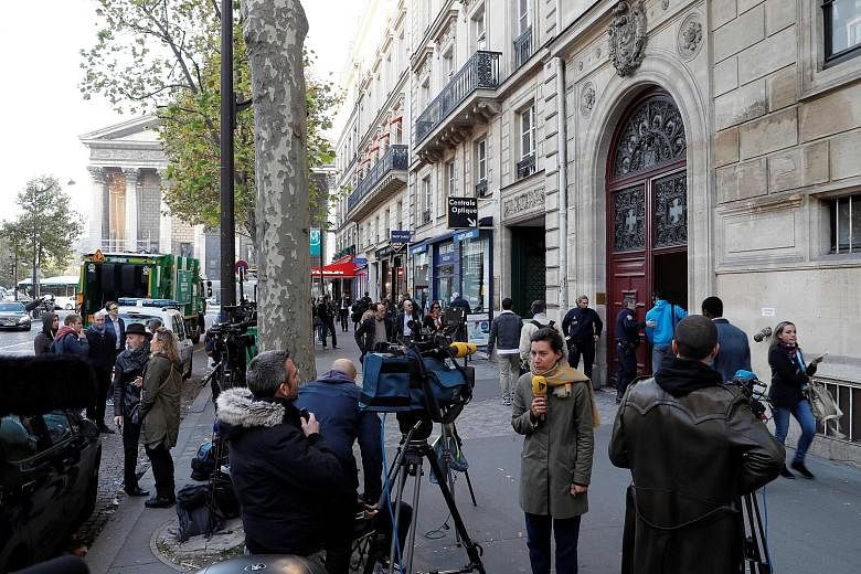 Reporters and police at the entrance to a hotel residence in Paris where reality TV star Kim Kardashian West was robbed at gunpoint in October last year.