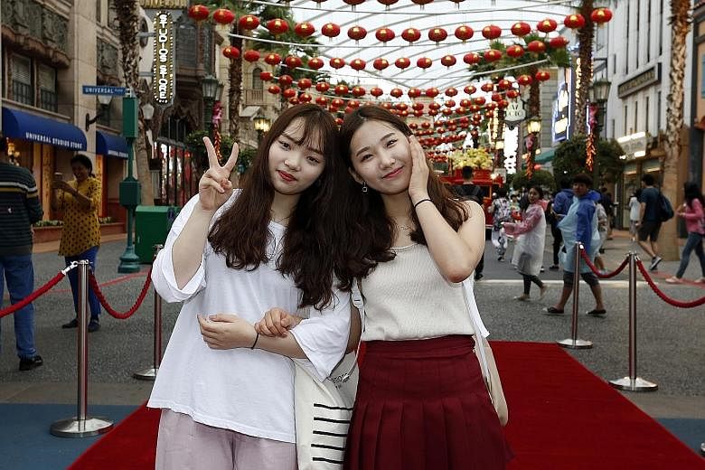 Theme parks are fun but two South Korean tourists had more than the usual share at Universal Studios Singapore (USS) yesterday when they received prizes worth $888. Ms Seon Mi Hwang (far left) and Ms Eun Ji Kim entered the theme park at 10am, helping