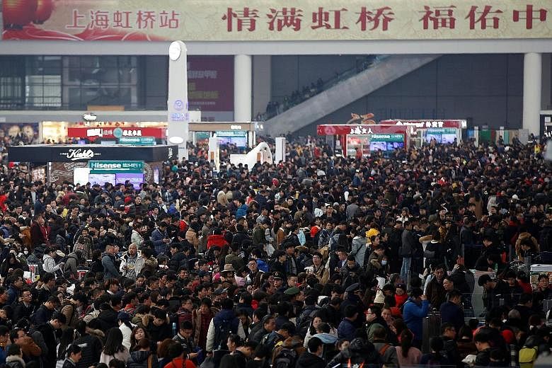 Passengers waiting to board trains at Shanghai's Hongqiao Railway Station yesterday. Although hundreds of millions of workers will return to their hometowns, outbound travel for the holiday break is expected to top a record six million passengers, wi