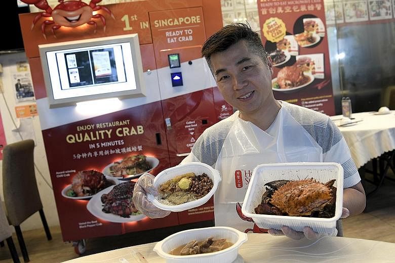 House of Seafood owner Francis Ng with the offerings from his vending machine - nasi lemak, black pepper crab and bak kut teh.