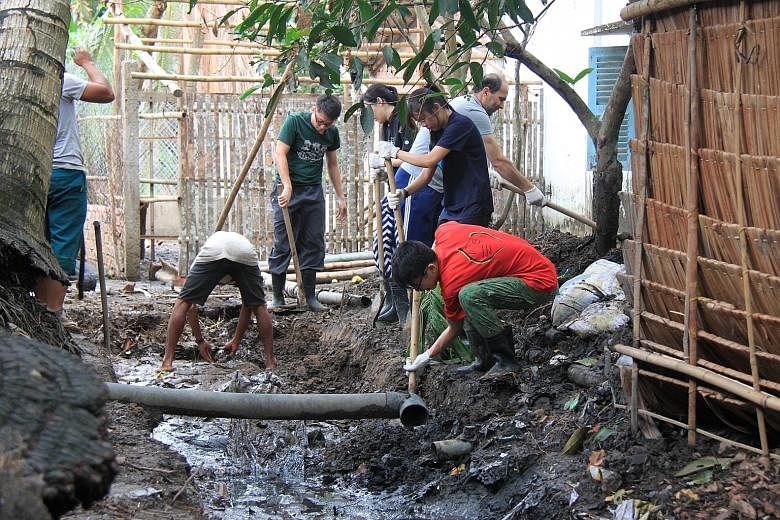 NTU students on Project Mai, in Vietnam, which involved building biogas systems to convert pig waste to methane, which can be used as cooking gas.