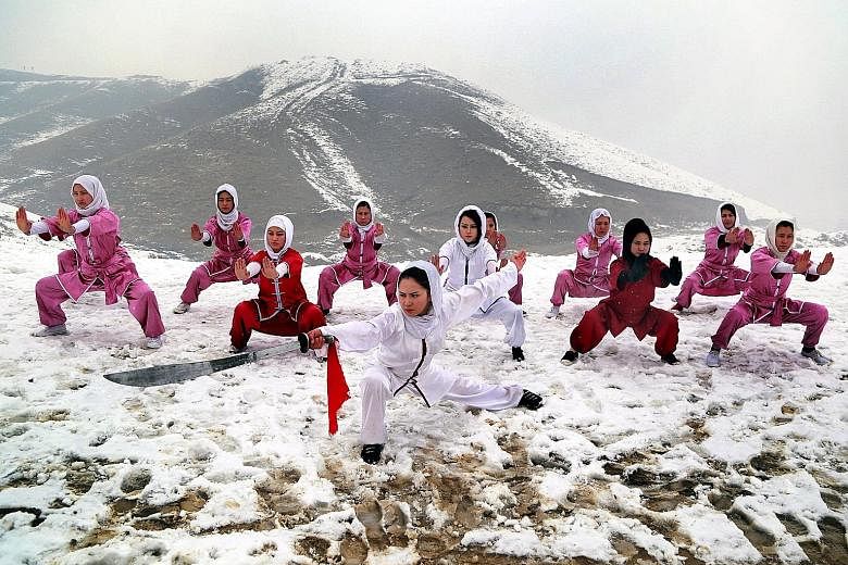 Afghan girls from the Shaolin Wushu Club practising their skills during a training session on the top of a hill in Kabul, Afghanistan, yesterday. There are 20 girls, whose ages are from 14 to 20 years, learning wushu in the club. The Afghan girls hav
