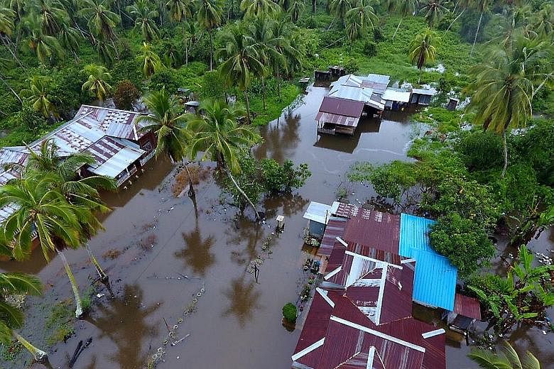 Flooded roads in Segamat, Johor. The state, which was the worst hit, faces more thunderstorms over the Chinese New Year weekend. Floodwaters hit houses in a Perak village as three days of relentless rain in Malaysia brought floods to nine of the coun
