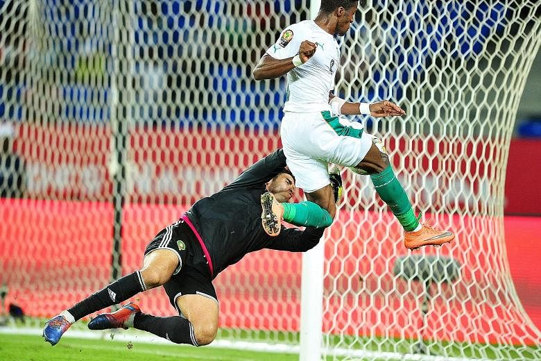 Ivory Coast forward Wilfried Zaha (No. 9) having his shot saved by Morocco goalkeeper Monir El Kajoui. Zaha could not breach the opposition backline as defending champions Ivory Coast were dumped out of the Africa Nations Cup, following a 1-0 loss to