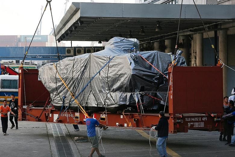 One of the nine Singapore Armed Forces Terrex armoured vehicles being prepared to be loaded onto a truck at a cargo terminal in Hong Kong yesterday afternoon. On Tuesday, more than two months after the vehicles were detained while in transit on the w
