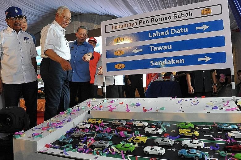 Prime Minister Najib Razak (second from far left) with Sabah Chief Minister Musa Aman (in blue cap) at an event in Sabah last December. Mr Najib has reportedly agreed for an early election to be called in the state. Analysts expect this to pave the w