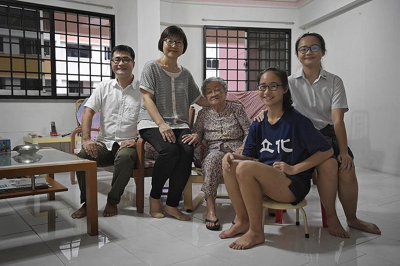 Mr Tan Chow Hua, his wife Woon Chay Lee, Mr Tan's mother Loh Khim and the couple's daughters Si Qi (right), 17, and Si Min, 15, at Madam Loh's home in Jurong West. In March, Madam Loh will move in with the family to a 3Gen flat in Boon Lay View.