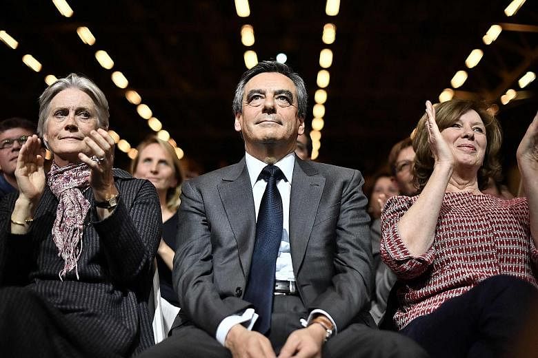 French presidential candidate Francois Fillon with his wife Penelope, who, according to a newspaper, was paid around €500,000 (S$761,000) in public money for a no-show job.