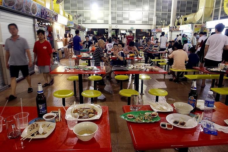Dirty plates and cutlery left at tables are a common sight at many food centres here. The writer says automation could help to improve cleanliness.