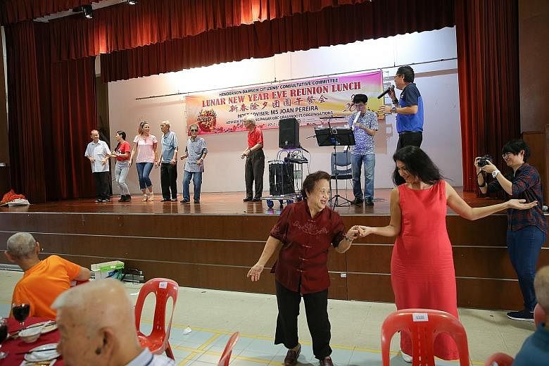 Mrs Kavita dancing with a beneficiary at the Chinese New Year reunion lunch event organised by Henderson-Dawson CCC yesterday.