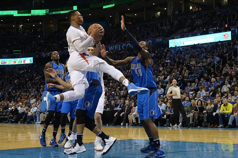 Oklahoma City Thunder Russell Westbrook driving to the basket as Dallas Mavericks forward Harrison Barnes (No. 40) attempts to stop him. The Thunder point guard, who had 45 points on the night, was named in the Western Conference team's reserves rost