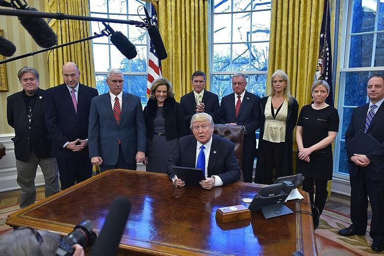 Mr Trump after signing an executive order on defeating ISIS in the Oval Office of the White House on Saturday. On Friday, he signed an order that bars the entry of foreign nationals from seven Muslim-majority nations, raising concerns around the worl