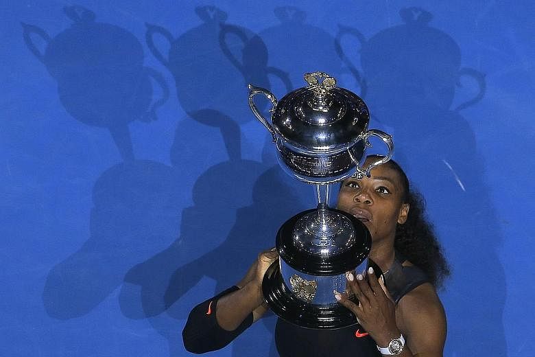Serena Williams with the Australian Open trophy on Saturday. She cited the "incredible" fighting spirit shown by Steffi Graf, Martina Navratilova, Chris Evert and Margaret Court.