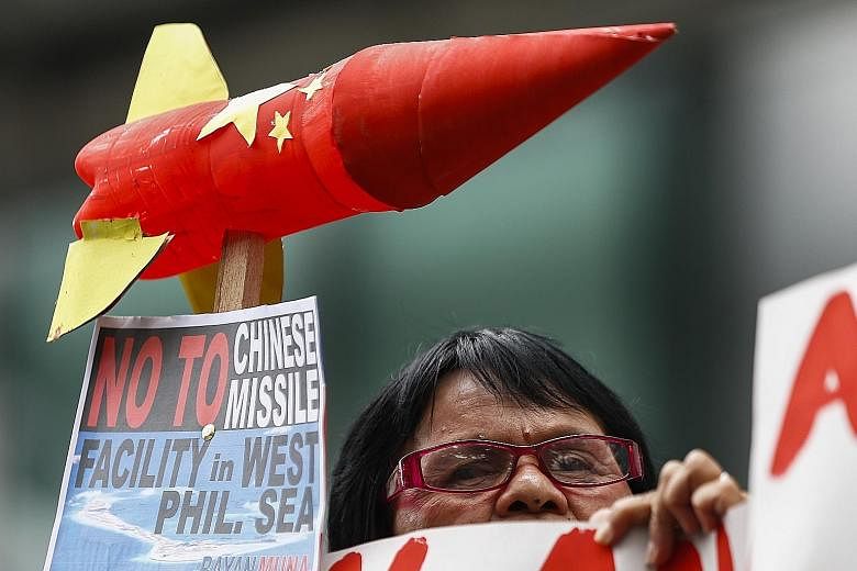 An activist protesting against Chinese military installations in the South China Sea, in Manila, last Tuesday. President Duterte said on Sunday that the US presence in his country is putting regional stability at risk and dragging the Philippines int