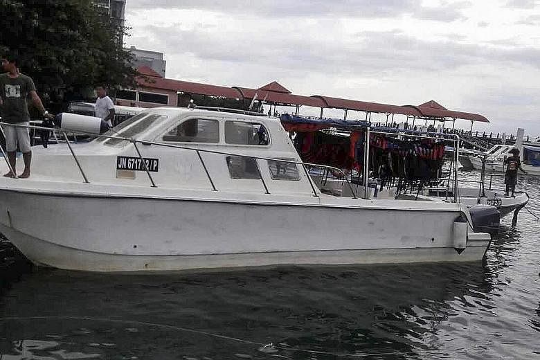 Above: A tourist catamaran in Kota Kinabalu, Sabah. Right: Anxious family members of the tourists from China arrived in Kota Kinabalu yesterday and were escorted to the hospital by Chinese embassy officials.