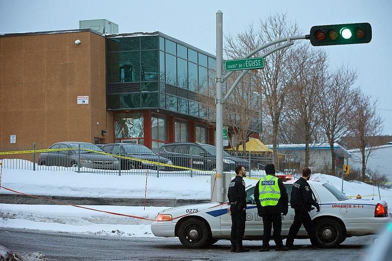 Police officers patrolling the area around the Islamic Cultural Centre in Quebec City yesterday, after Sunday's shooting during evening prayers. The attack came as Canada vowed to open its arms wide to Muslims and refugees after US President Donald T