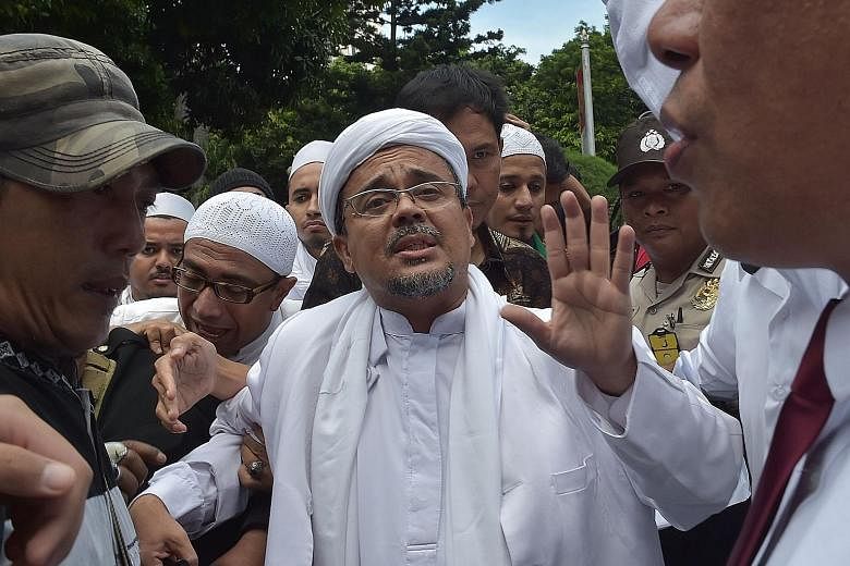 Mr Rizieq arriving at the Jakarta police headquarters on Jan 23. The Islamic Defenders' Front chairman had been jailed twice previously - in 2003 for inciting his followers to violently harass people at nightspots in Jakarta, and in 2008 for attackin