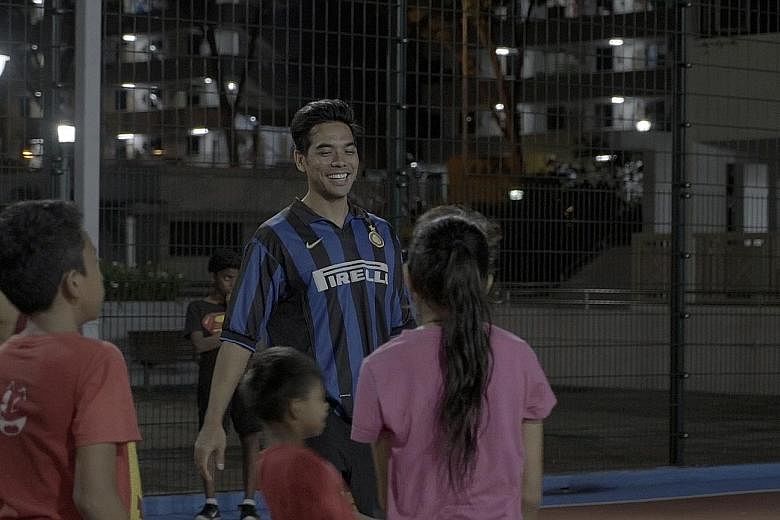 Mr Irza conducting a football training session at a street soccer court in Jalan Kukoh as part of the Catch Plus after-school programme. He hopes to ingrain the value of discipline in the children.