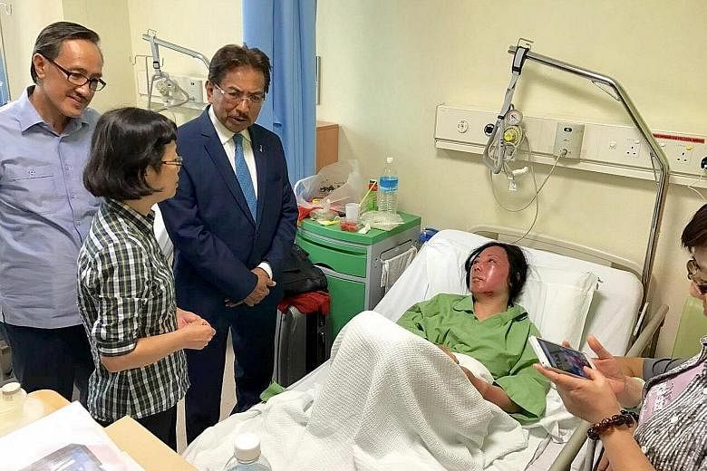 Sabah Chief Minister Musa Aman (wearing a tie) at the Queen Elizabeth Hospital in Kota Kinabalu yesterday visiting a survivor of the sinking incident. He was accompanied by the Chinese consul-general to Sabah, Ms Chen Peiji. The survivors are being t