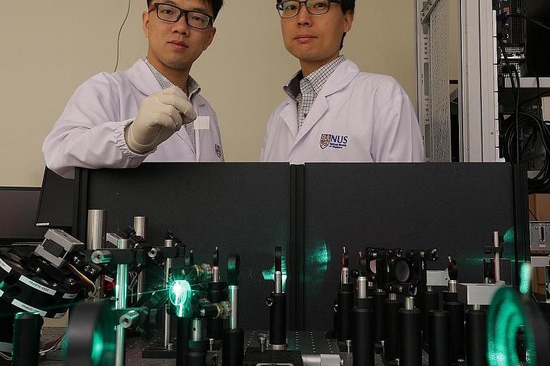 An NUS team, led by Dr Wu (left) and Prof Yang, has invented a cheap THz wave emitter after two years of research, potentially lowering costs in the field of terahertz technology.