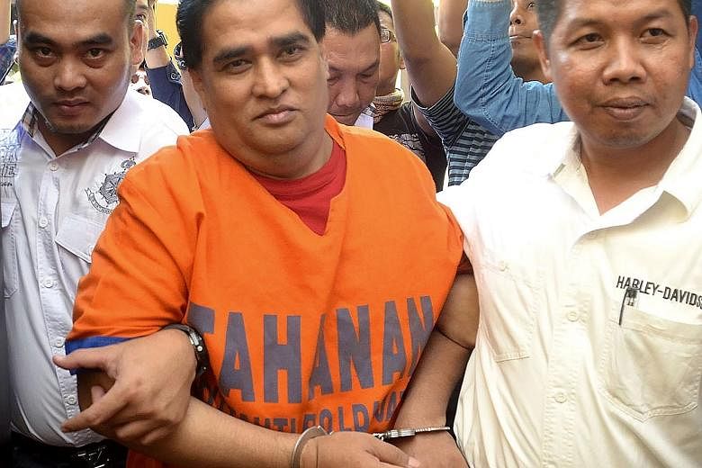 Pribadi being taken to police headquarters after his arrest last September for allegedly ordering the killing of two people.