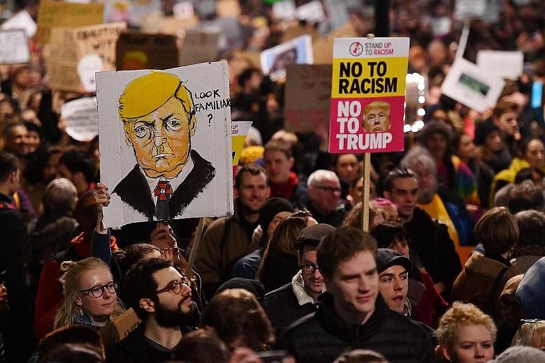 Protesters in London rallying against Mr Trump on Monday outside the Downing Street residence of British Prime Minister May. Some 1.6 million people have signed a petition calling for his planned trip to Britain to be cancelled.