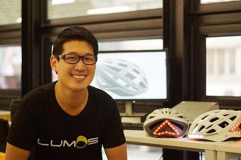 Mr Ding with prototypes of his brainchild, the award-winning Lumos helmet. The bicycle helmet has automatic brake lights and integrated turn signals to improve safety for cyclists.