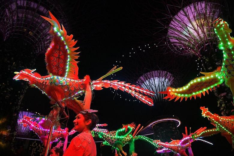 An all-female troupe from the Tian Eng Dragon and Lion Dance Centre brought to life handcrafted phoenixes with LED lights at Gardens by the Bay last night, in a performance sneak peek. The largest - at 11.16m in length and 5.05m in width - entered th