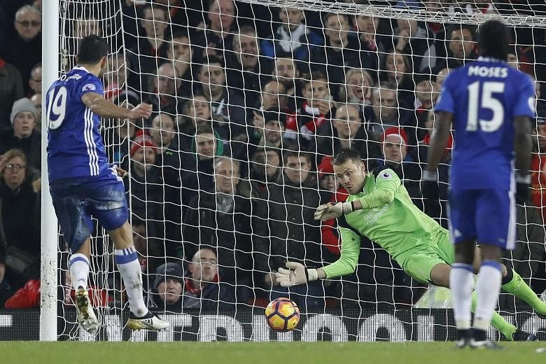 Simon Mignolet saving Diego Costa's penalty in the 76th minute. Chelsea drew 1-1 at Liverpool and are nine points ahead of closest Premier League rivals Tottenham and Arsenal.